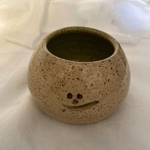 Small pottery jar. Handcrafted. Smiley face cutout